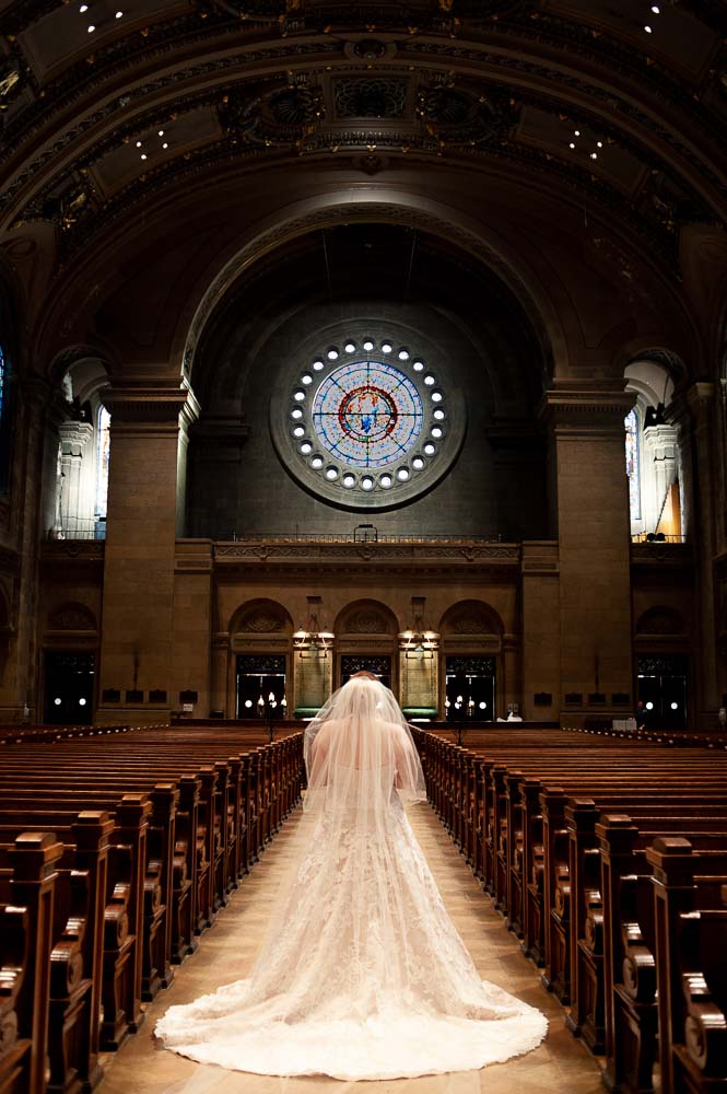 bride wearing a veil in The Basilica of Saint Mary for her Minneapolis wedding
