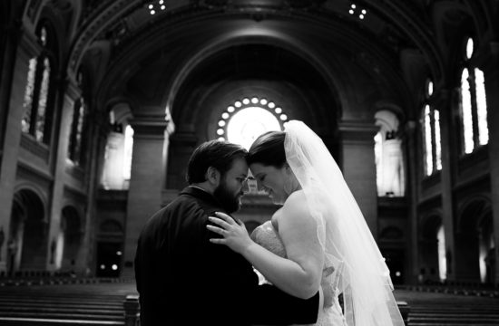 bride and groom touching foreheads at The Basilica of Saint Mary