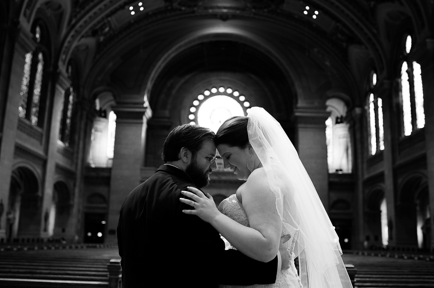 bride and groom touching foreheads at The Basilica of Saint Mary