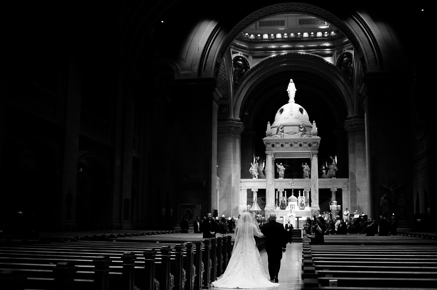 bride and her father during the processional atThe Basilica of Saint Mary in Minneapolis