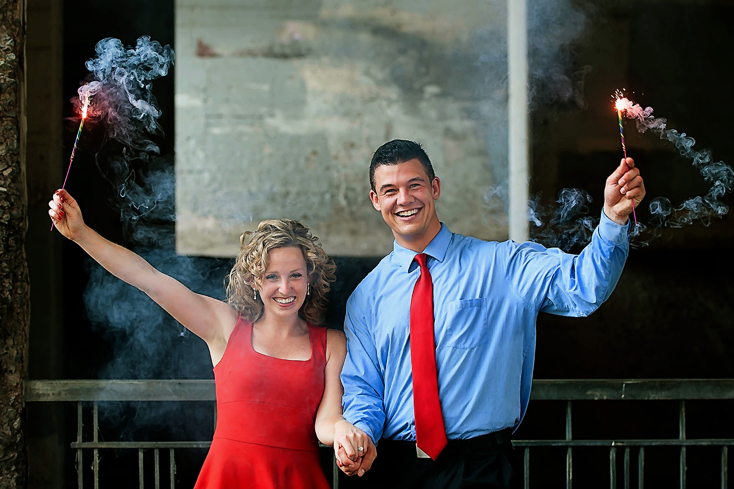engaged couple holding sparklers