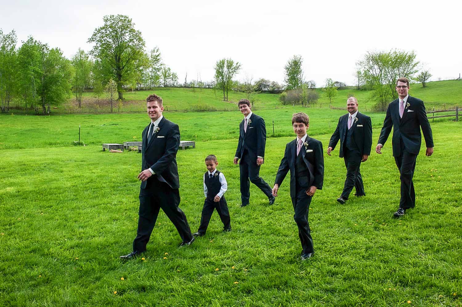 groom walking with the groomsmen at the Enchanted Barn in Wisconsin
