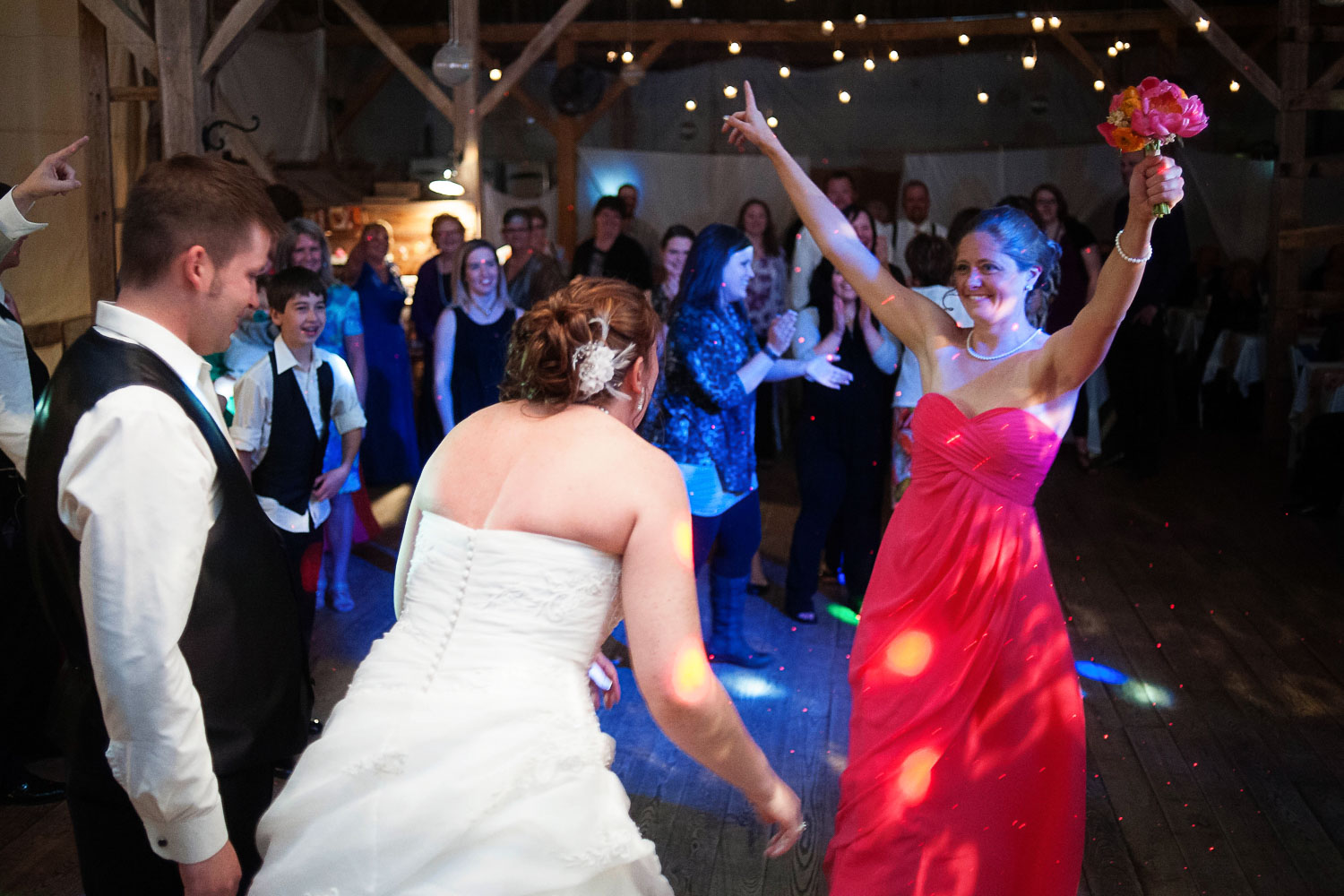 bridesmaid catching the bouquet at the Enchanted Barn
