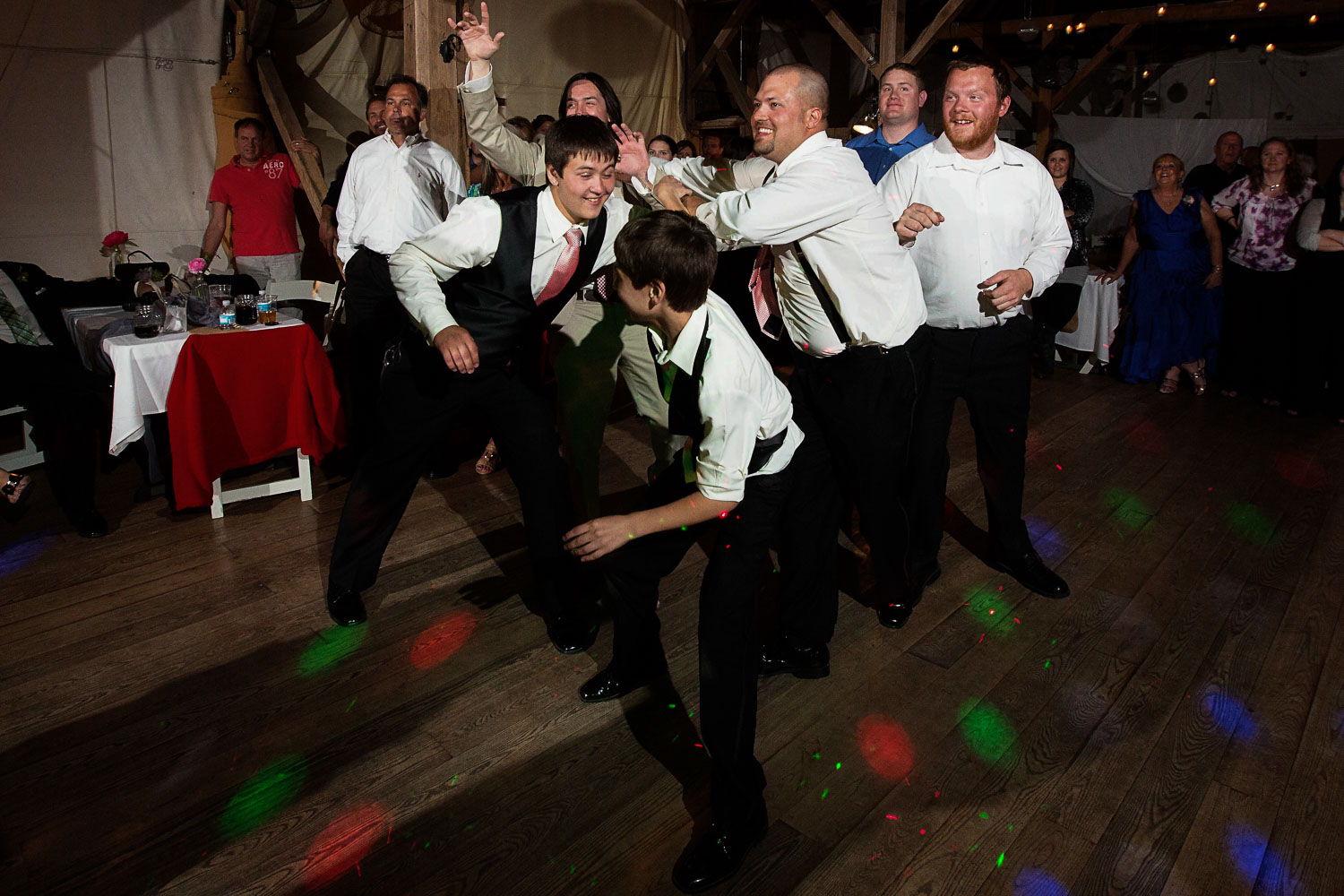 boys catching the garter at a wedding at the Enchanted Barn in Wisconsin