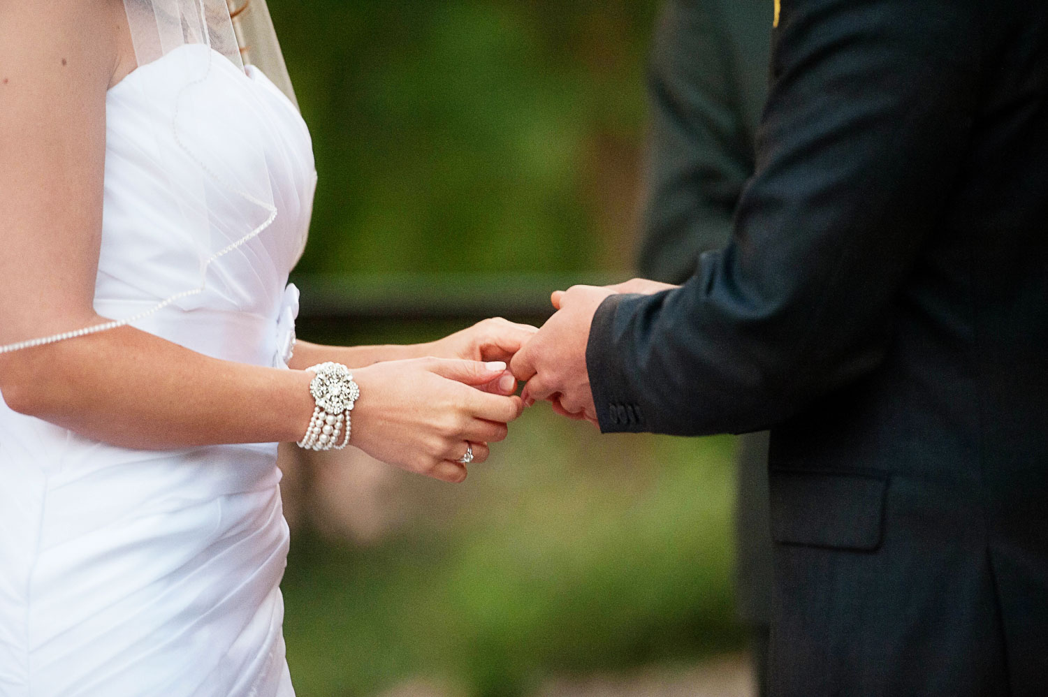 exchanging rings at their Como Zoo wedding