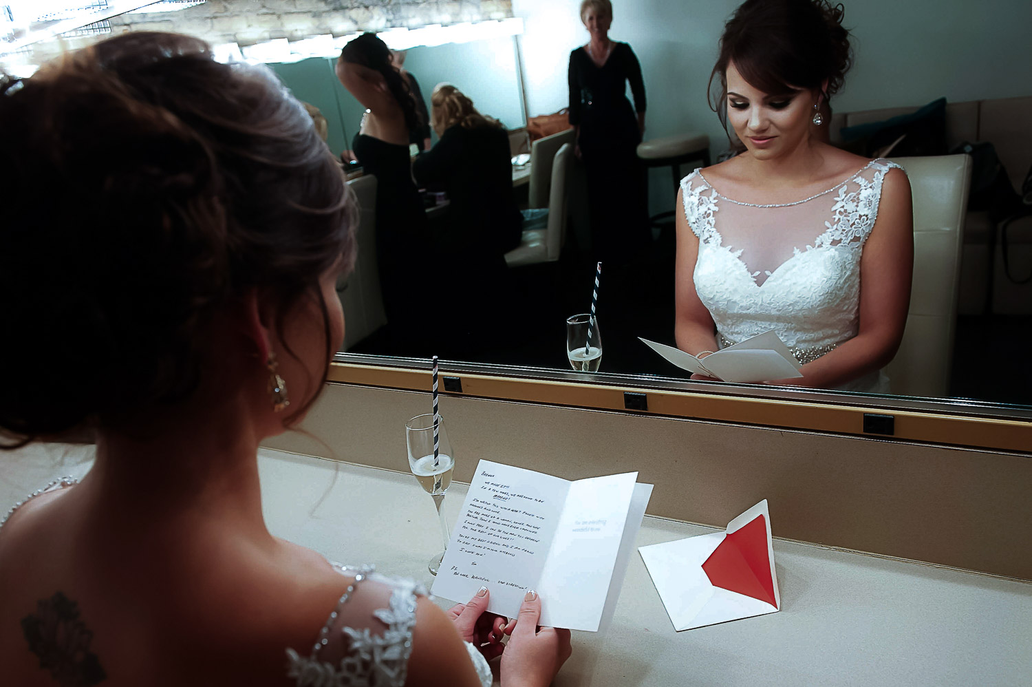 bride reading a letter from the groom on her wedding day at Aria