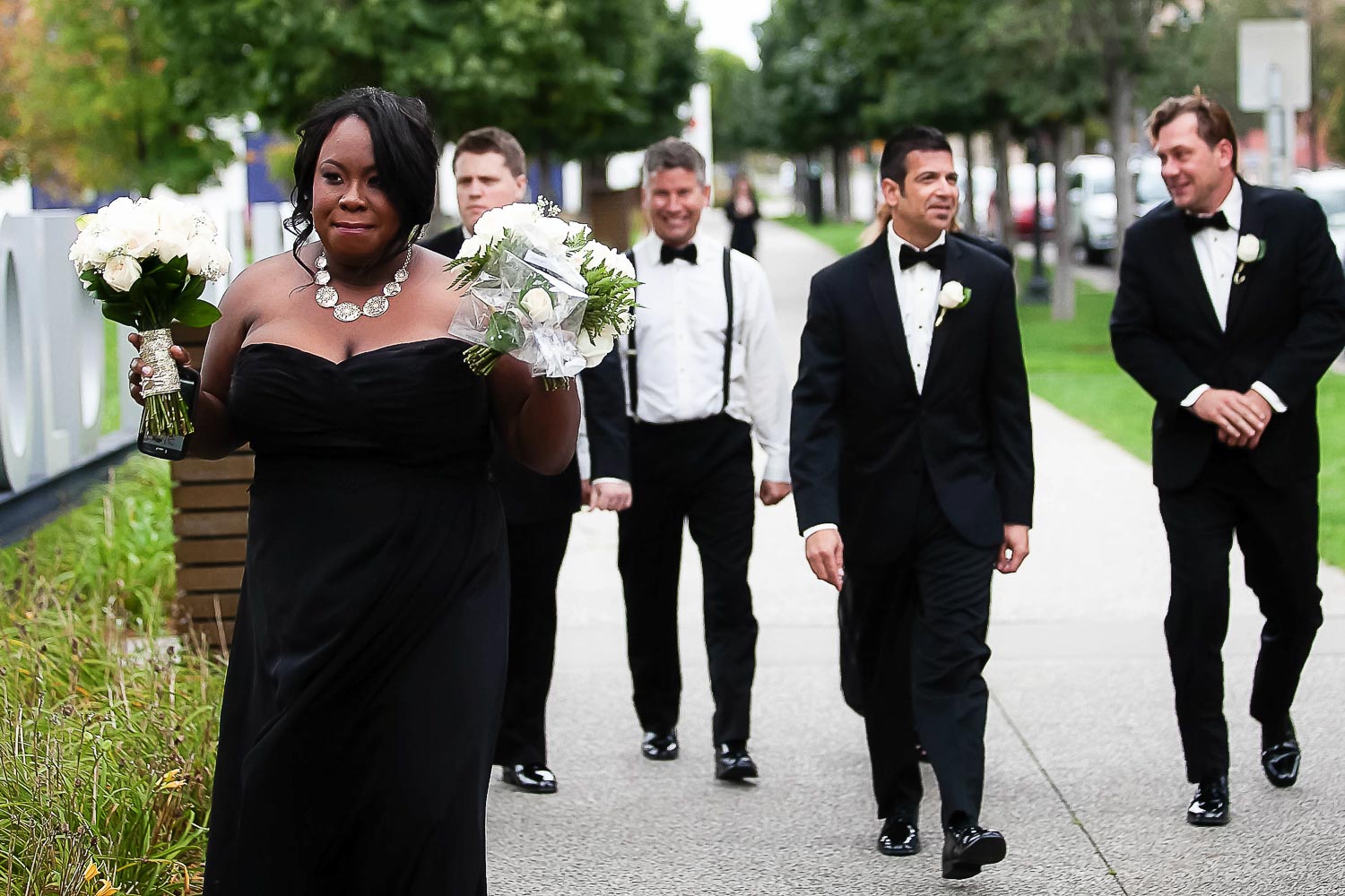wedding party walking in Gold Medal Park in Minneapolis