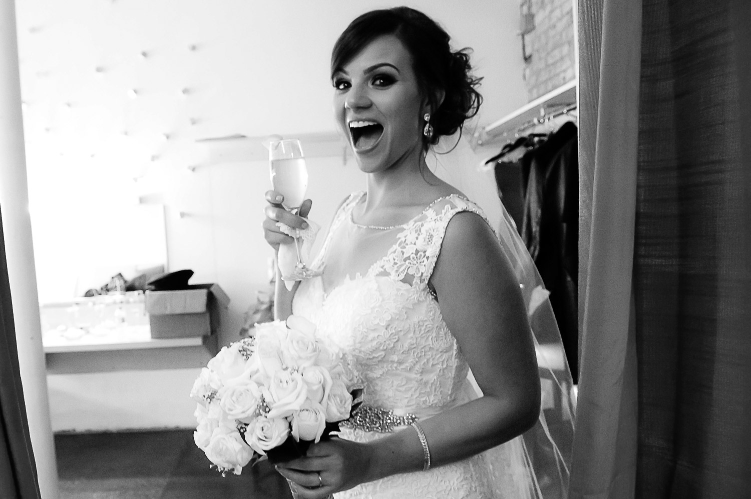 bride holding a glass of champagne after the wedding ceremony at Aria in Minneapolis 