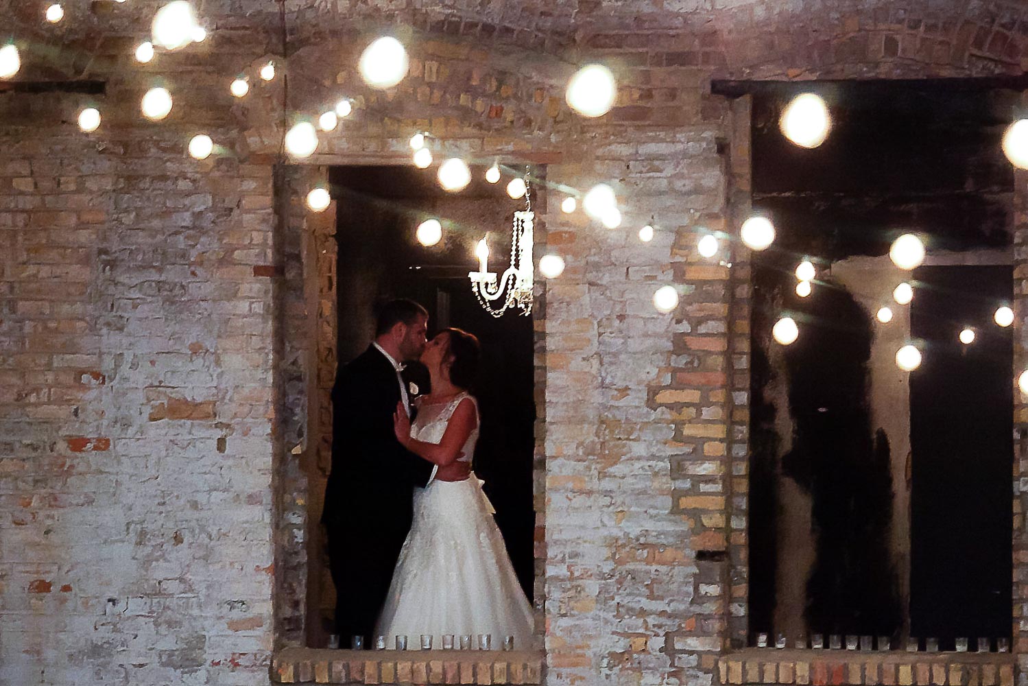 bride and groom in window at Aria in Minneapolis