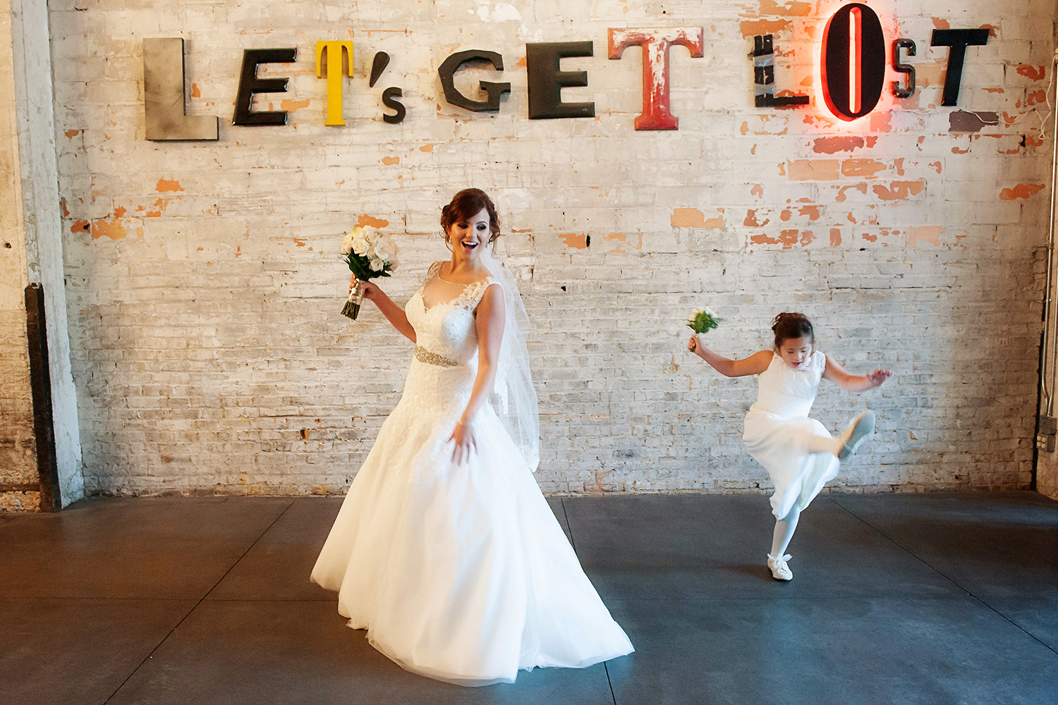 bride dancing with flower girl