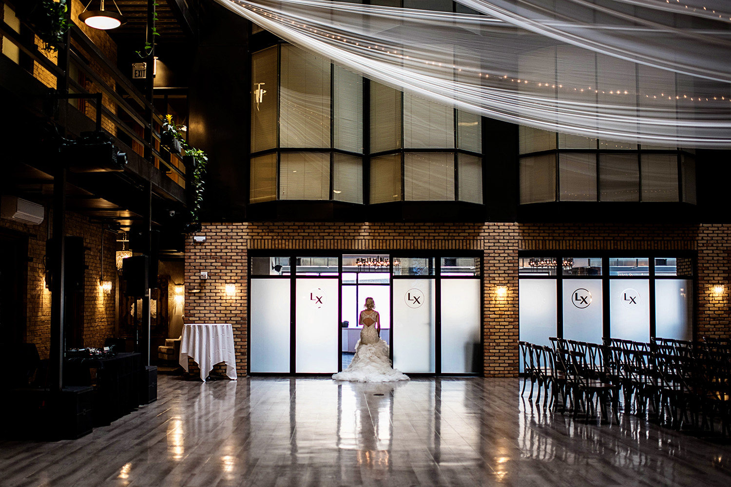 bride walking through a door at the lumber exchange building in the fountain room