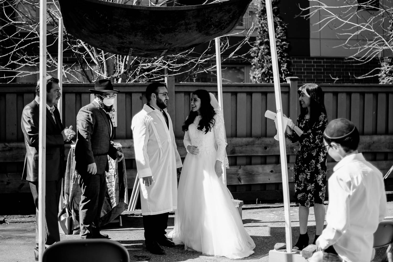 Jewish bride and groom under the chuppah during their covid-19 wedding in minneapolis