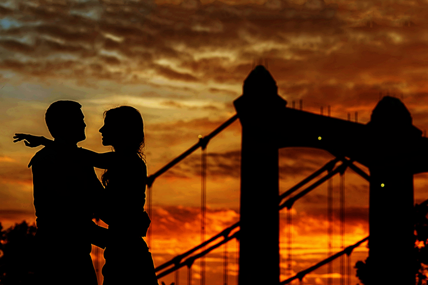 bride and groom silhouette at sunset in front of the Washington bridge in Minneapolis 