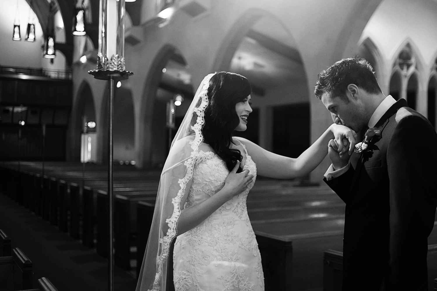groom kissing his brides hand after their first look