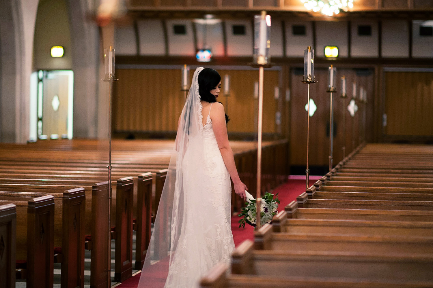 bride in a cathedral veil in the church