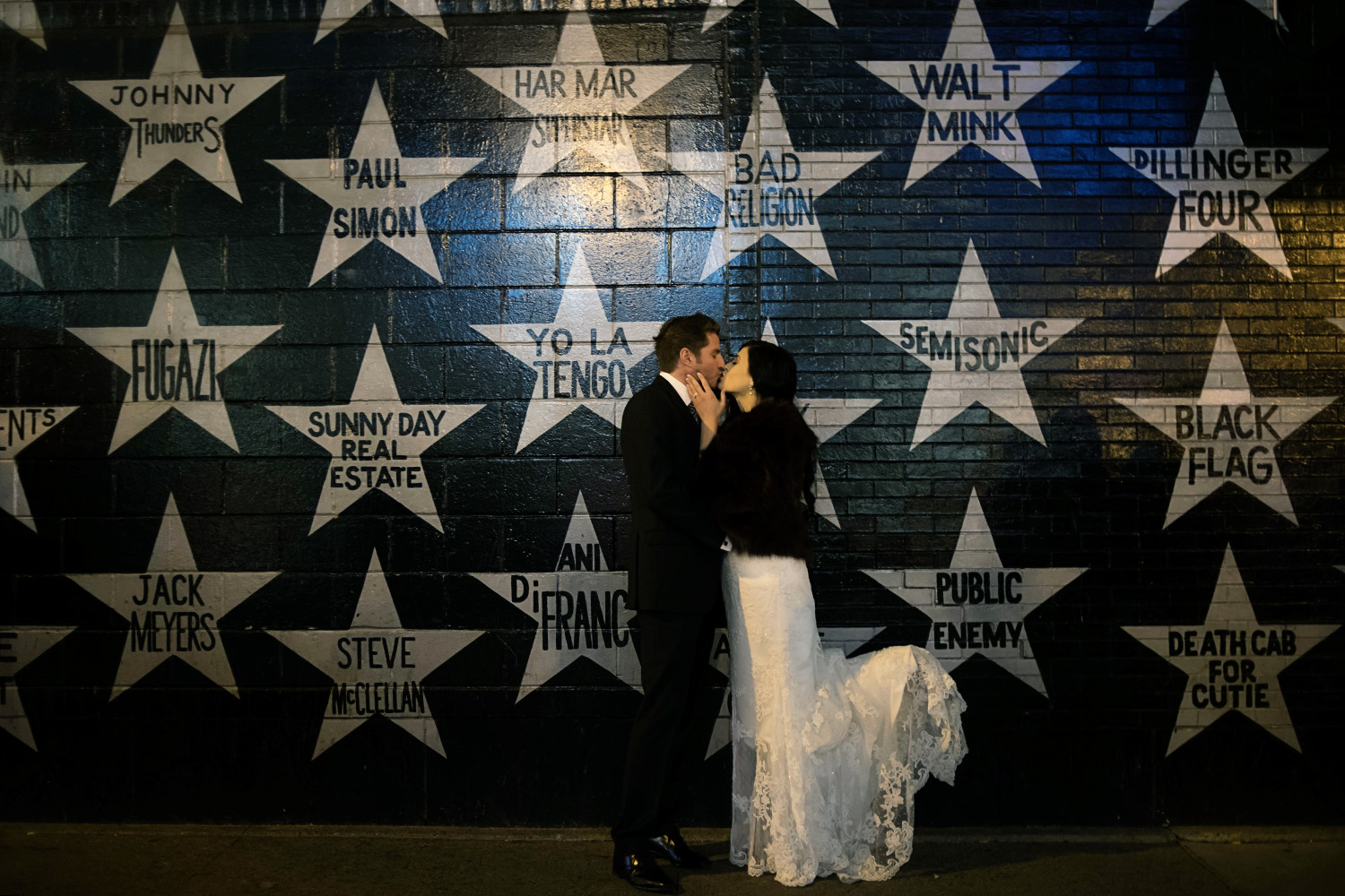 bride and groom kissing in front of First Avenue in Minneapolis
