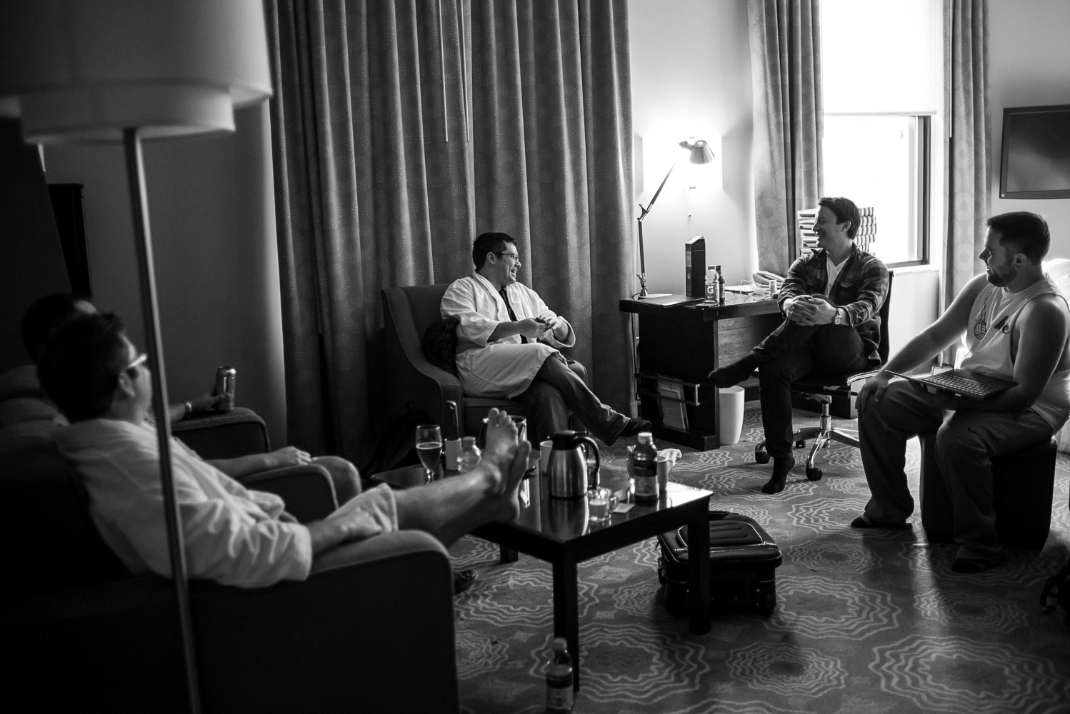 groomsmen hanging out in the hotel room before the wedding