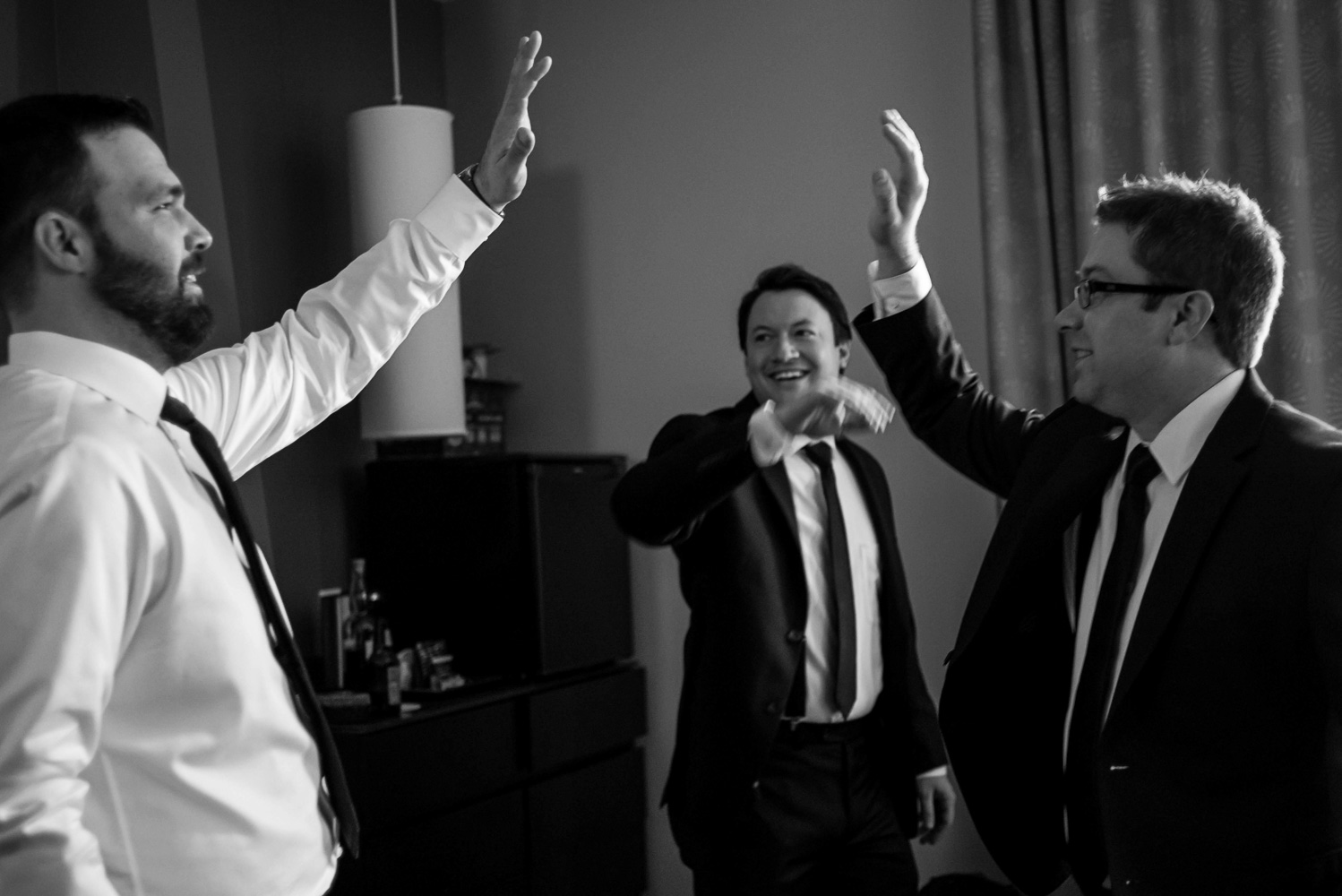 groomsman giving a high five to the groom