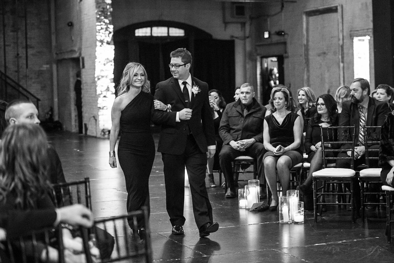 groom walking down the aisle with a bridesmaid before the ceremony at Aria in Minneapolis