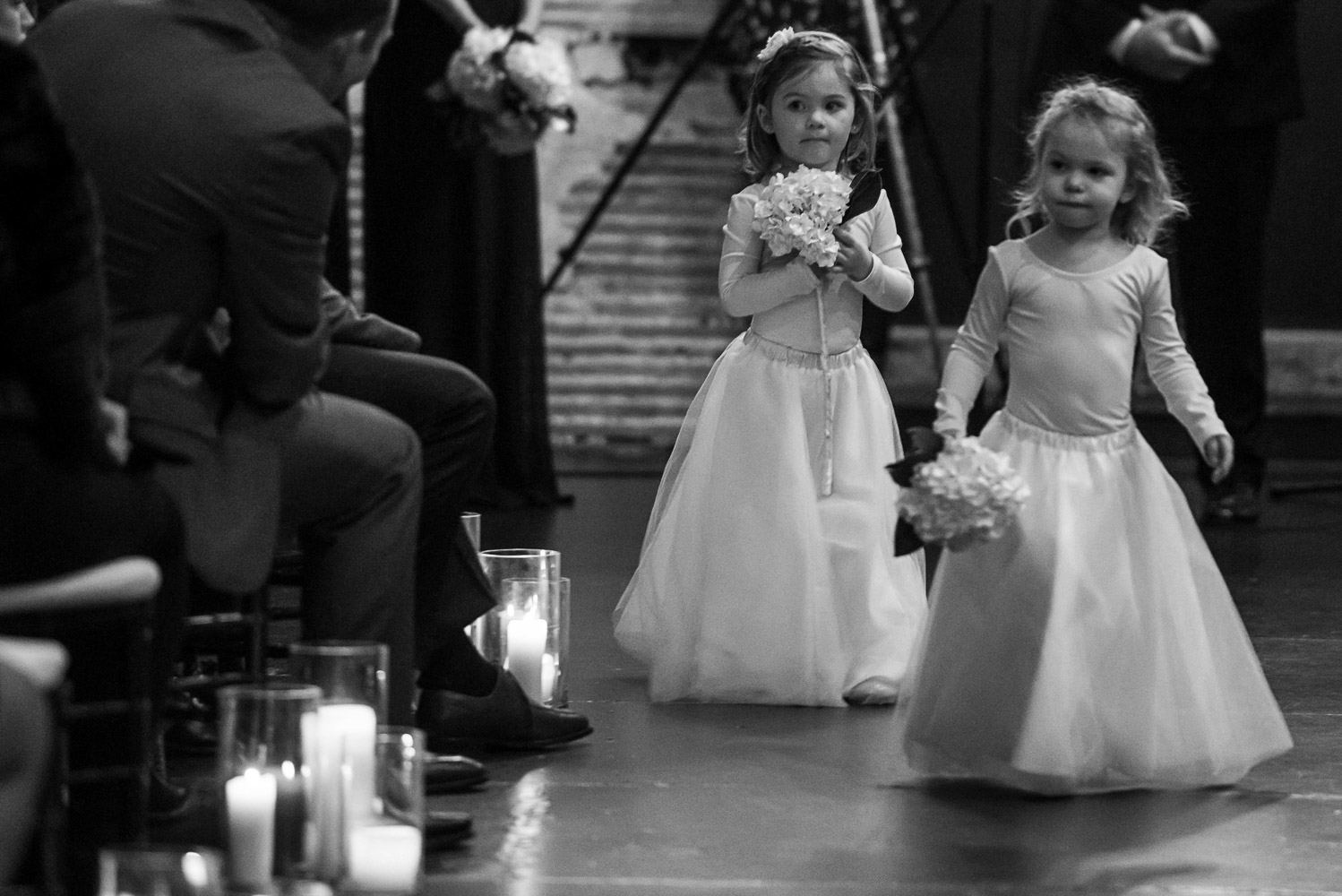 flower girls walking down the aisle before the ceremony at Aria in Minneapolis
