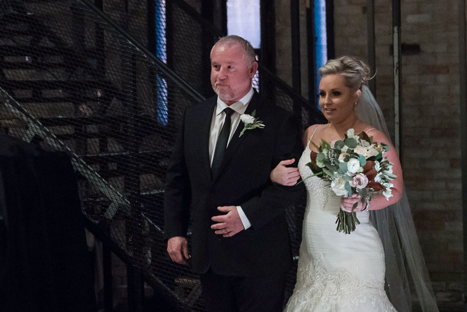 bride walking down the aisle with her father during the recessional at Aria Minneapolis