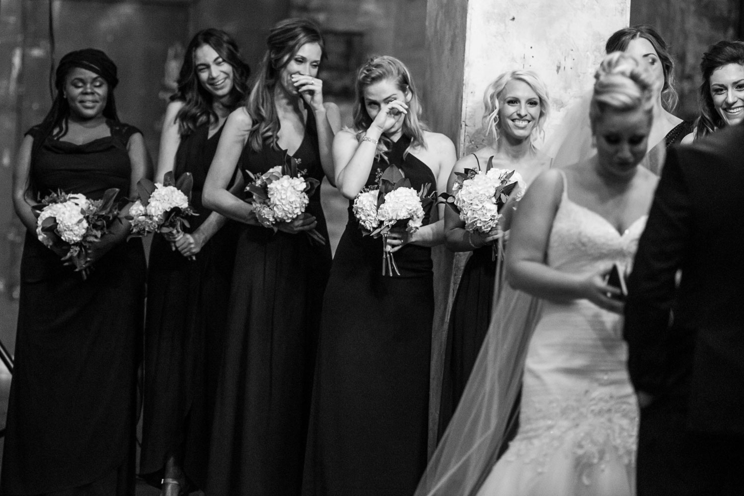 bridesmaids crying during the wedding ceremony at Aria in Minneapolis