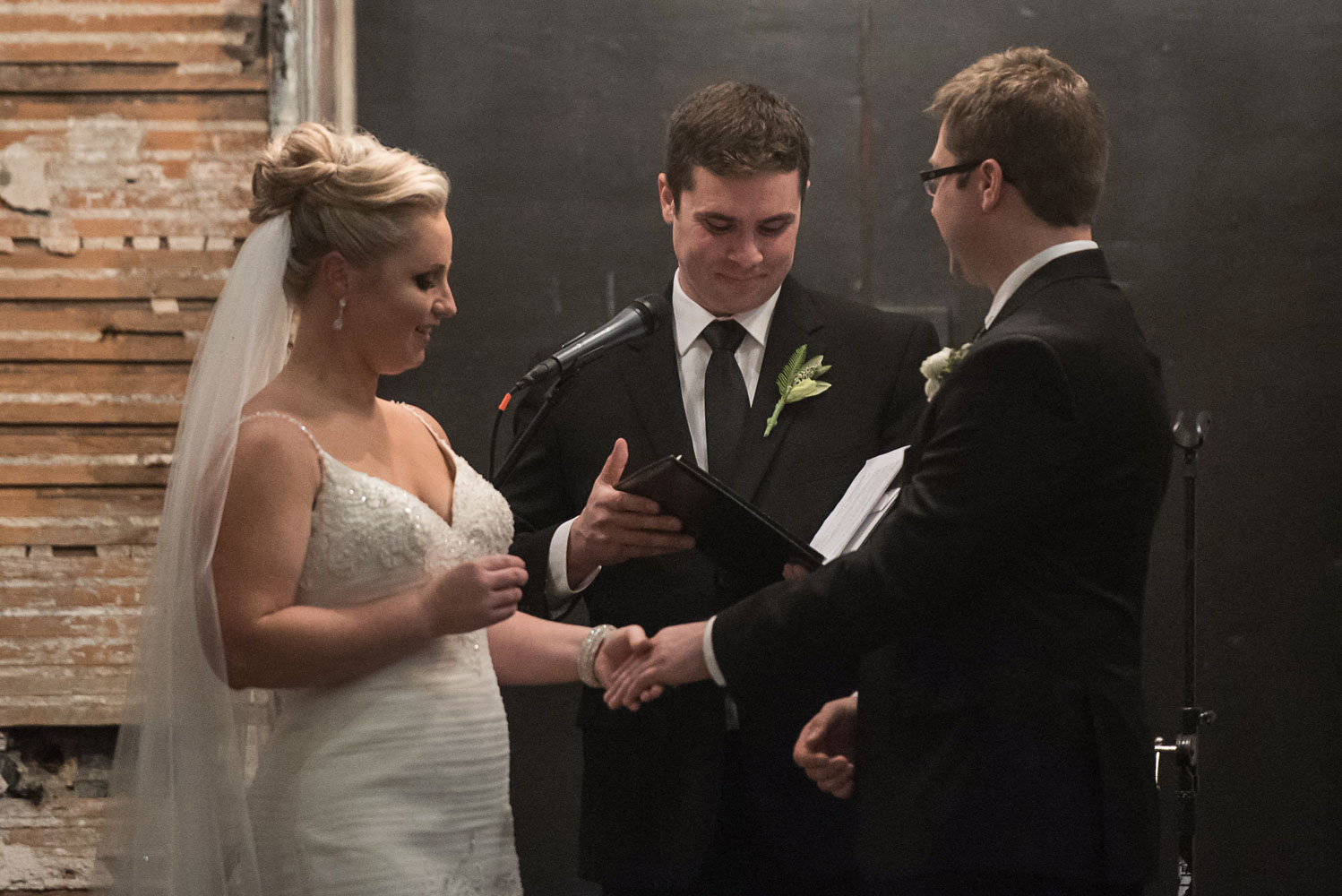bride and groom exchanging rings during their Aria wedding ceremony