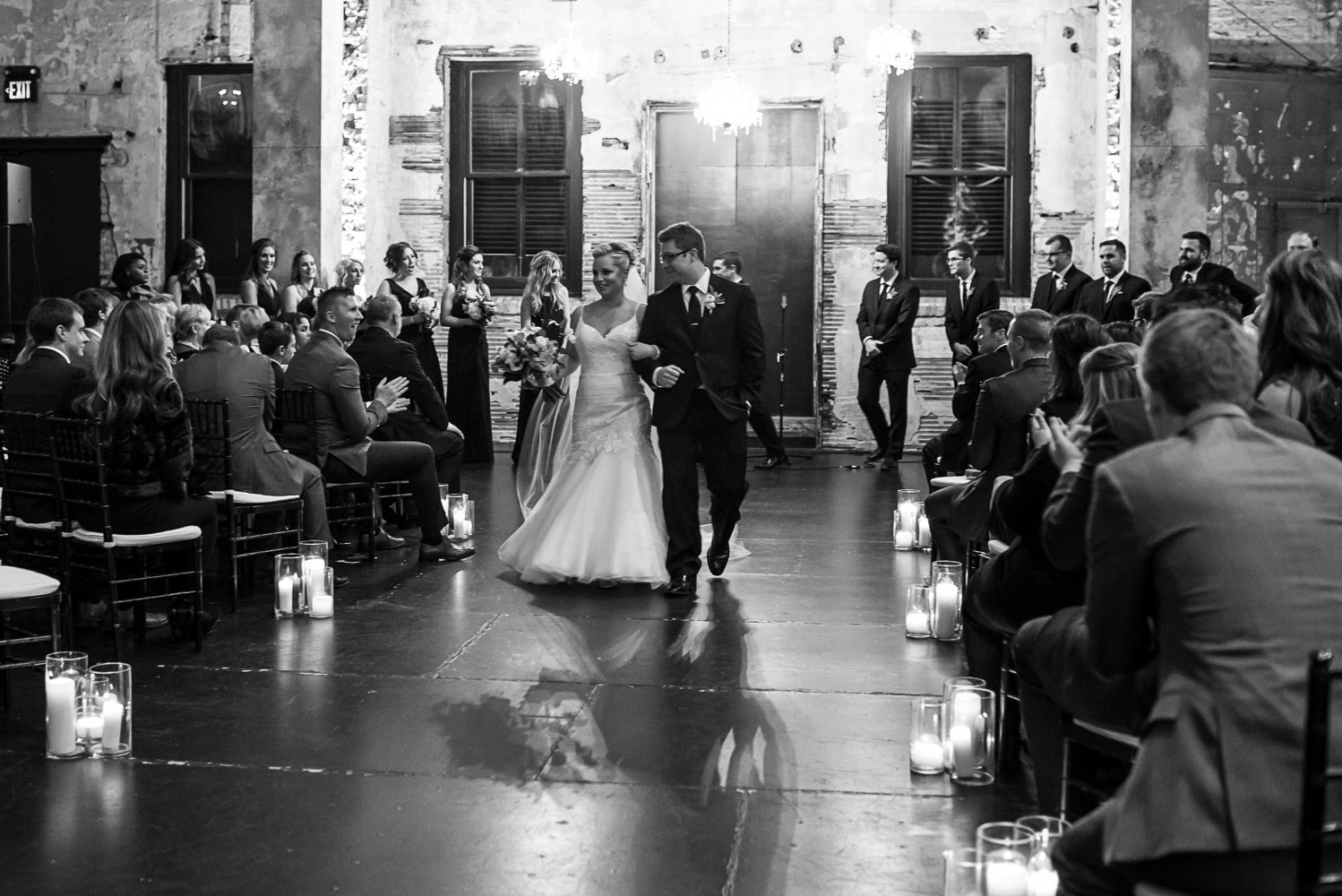 bride and groom walking out after the ceremony at Aria