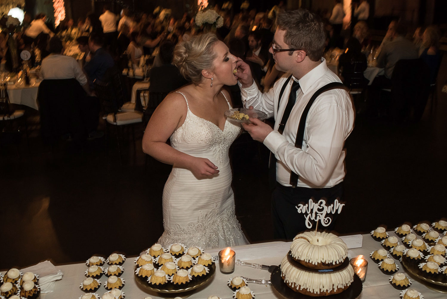 bride and groom feeding each other cake at Aria Minneapolis