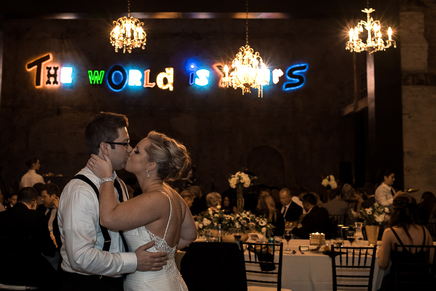 bride and groom kissing during their reception at Aria