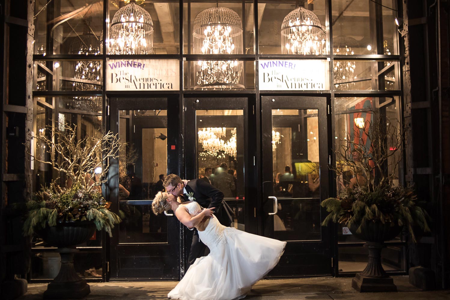 groom dipping the bride outside of Aria in Minneapolis