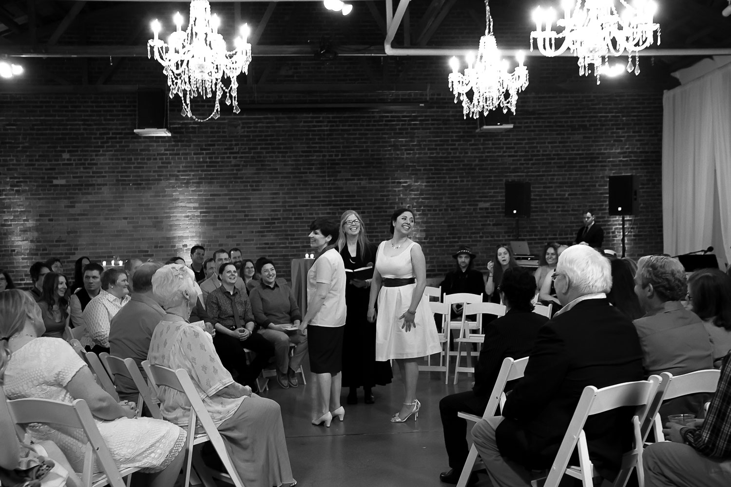 wedding in the round set up with the brides looking at their guests at Neu Neu in Minneapolis