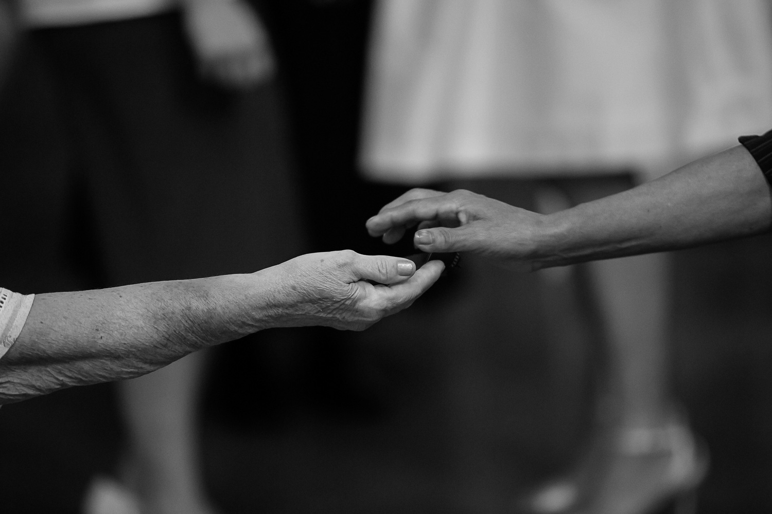 guests passing the wedding ring around to bless it during the wedding ceremony at Neu Neu Minneapolis