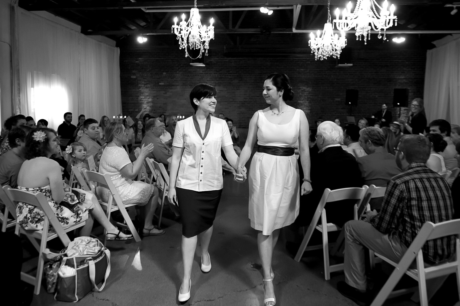 same sex couple walking down the aisle after their wedding ceremony in Minneapolis at Neu Neu
