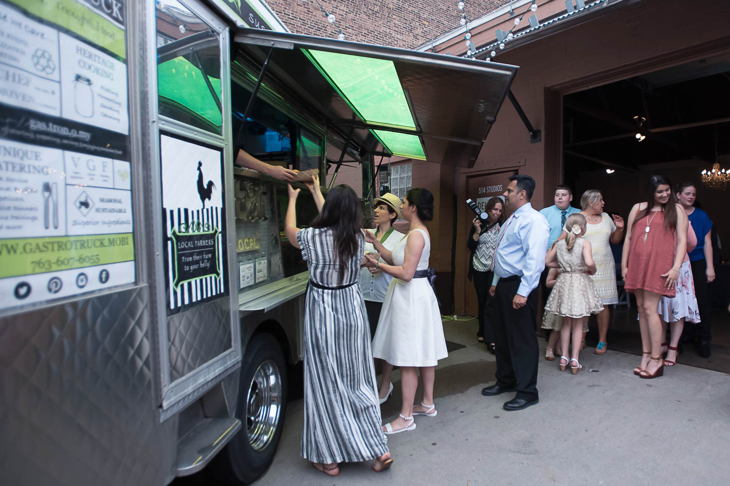 wedding guests in line at a food truck for dinner at the wedding reception at Neu Neu in Minneapolis