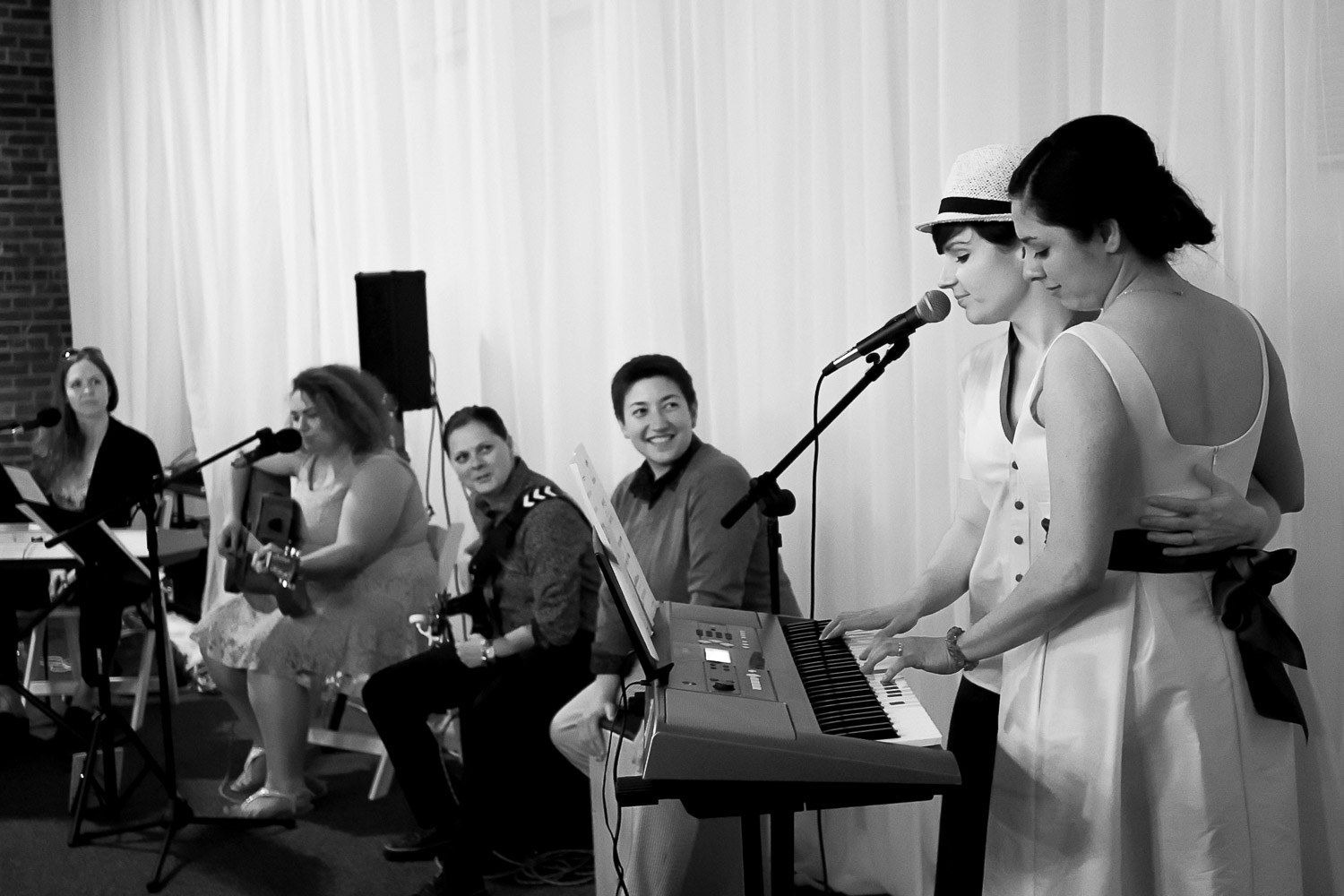 same sex couple playing the keyboard to start the first dance at Neu Neu in Minneapolis