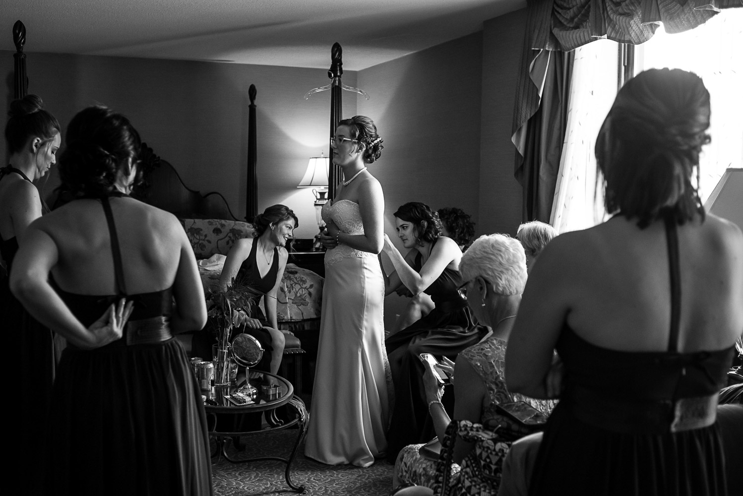 bride getting on her wedding dress in her hotel room in St Paul