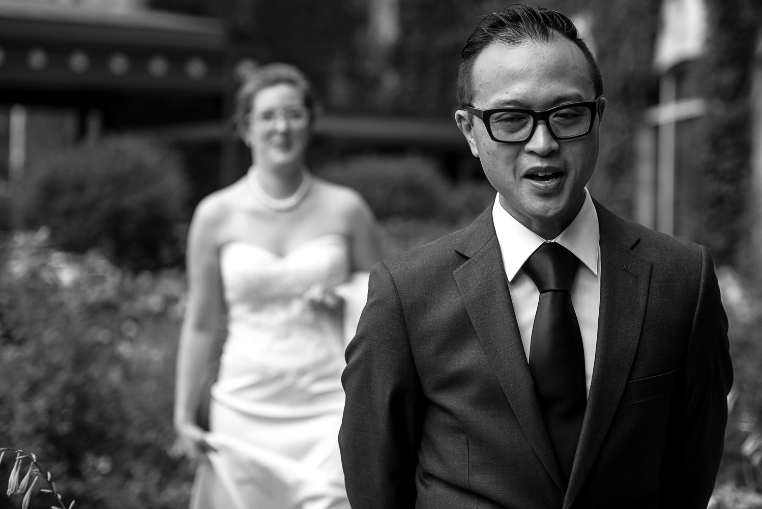 bride walking to meet the groom for their first look in from of the St Paul hotel