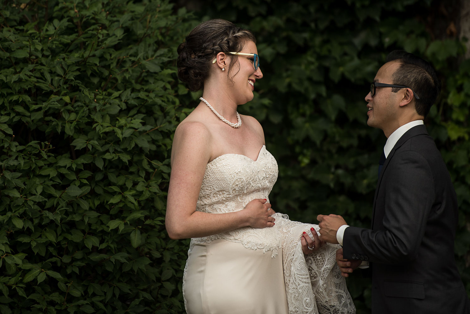 bride and groom portrait in front of an ivy wall