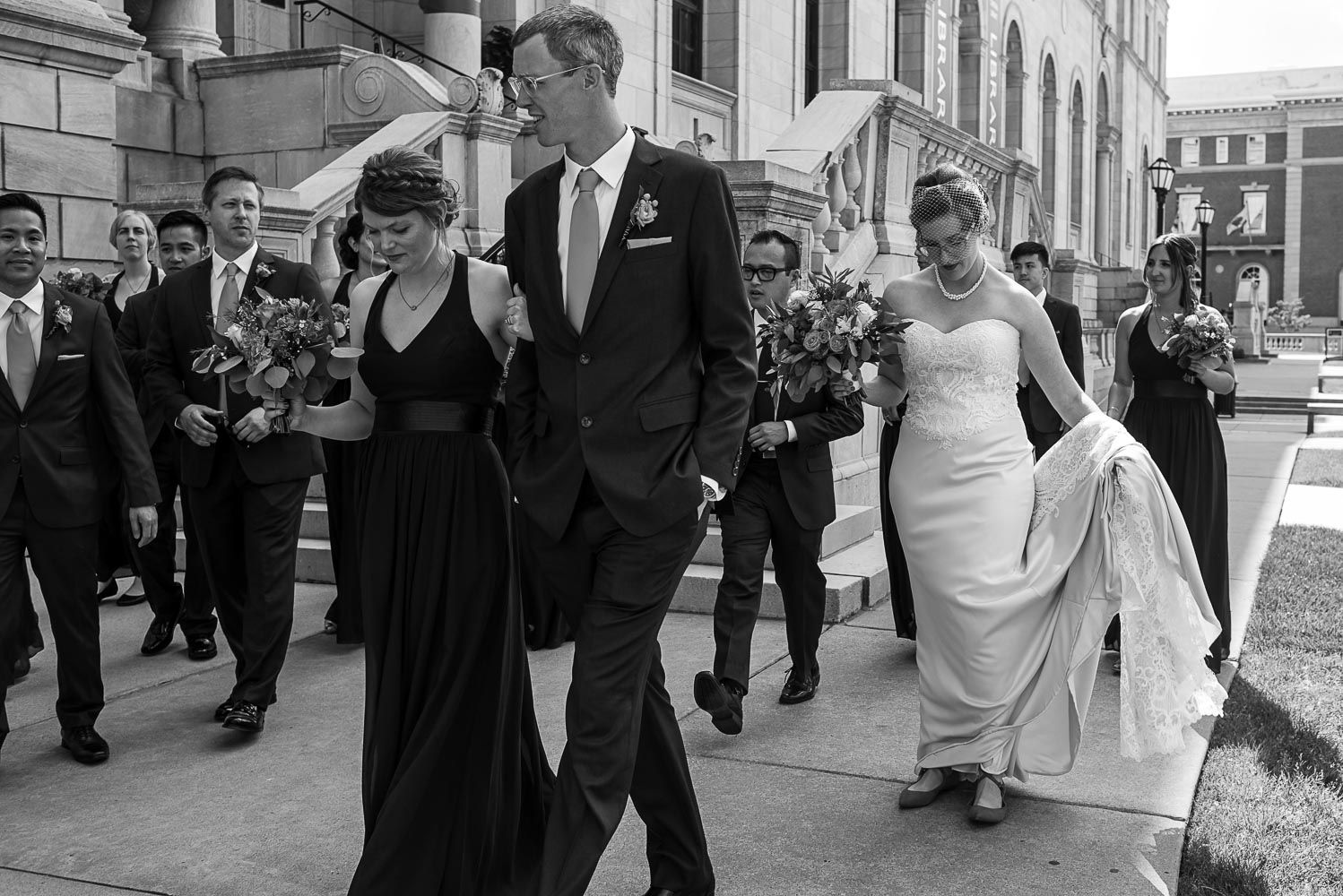wedding party walking together in front of the James J Hill Library