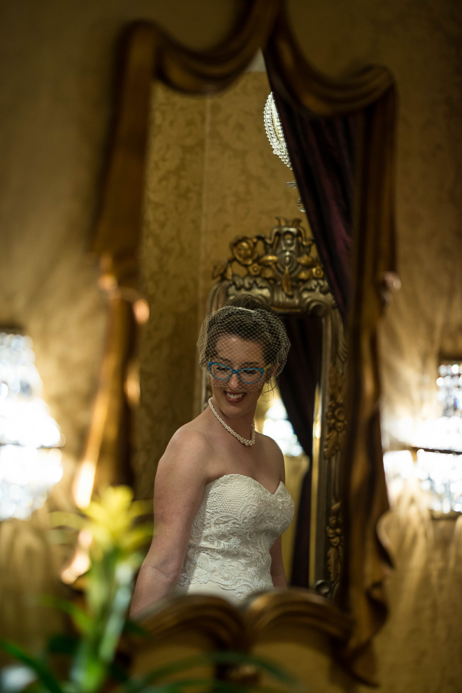 bride in front of a gold mirror