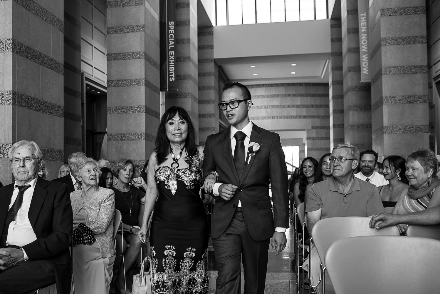 groom walking down the aisle with his mom at the Minnesota History Center