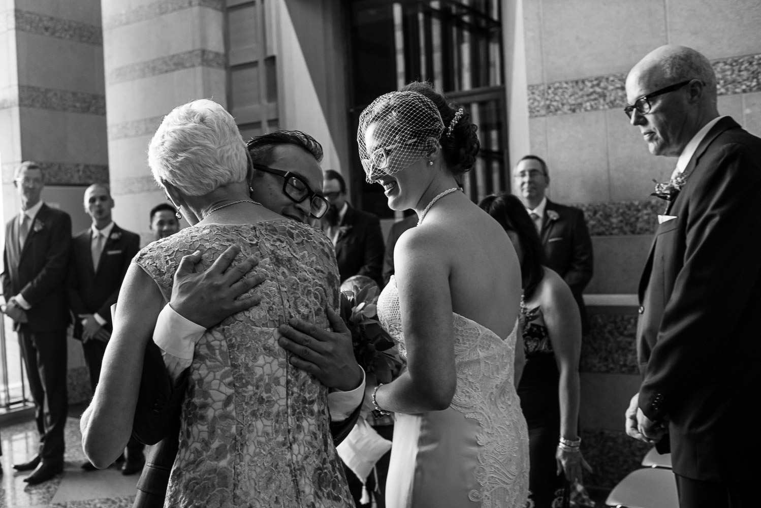groom hugging mom during the wedding ceremony at the Minnesota History Center
