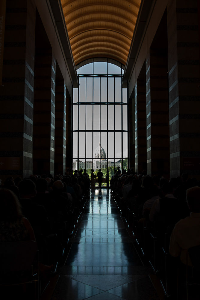 bride and groom getting married at the Minnesota History Center in St Paul in front of the capital