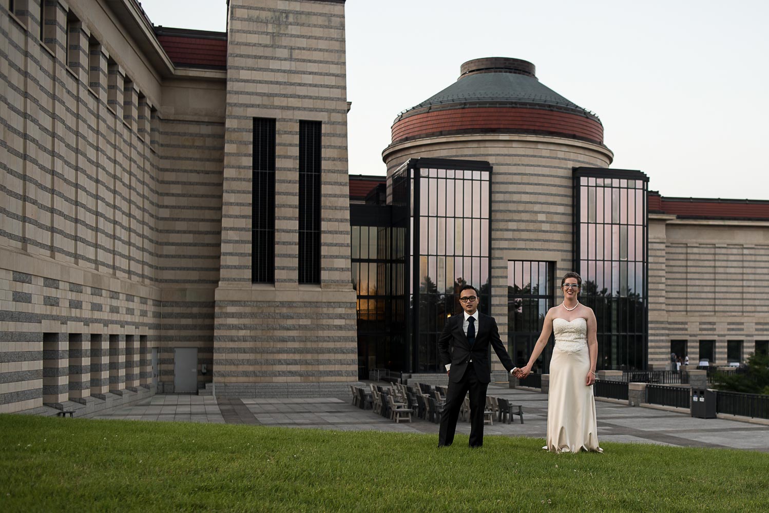 bride and groom holding hands outside of the Minnesota History Center