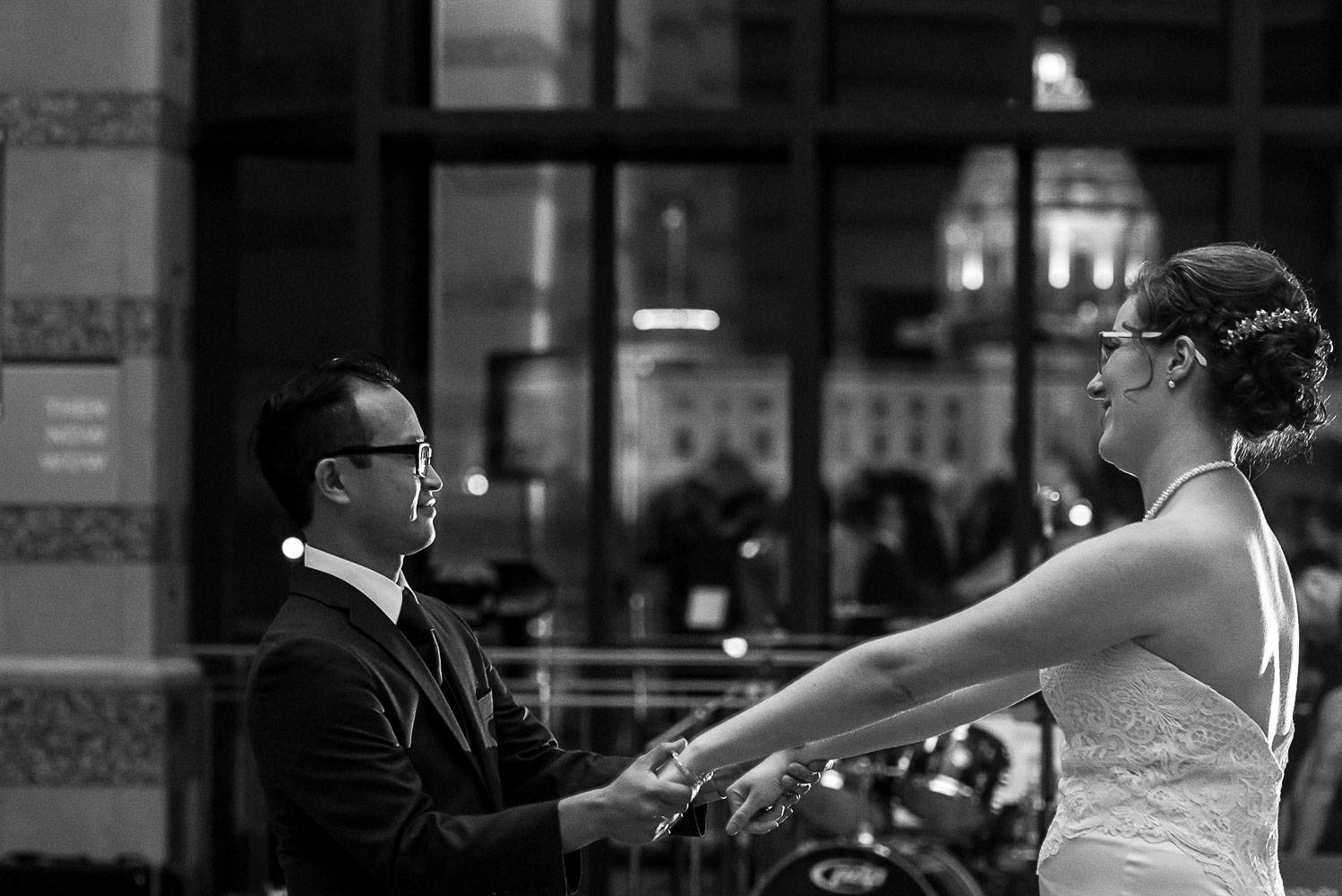 bride and groom's first dance in front of the window with a view of the Minnesota Capital
