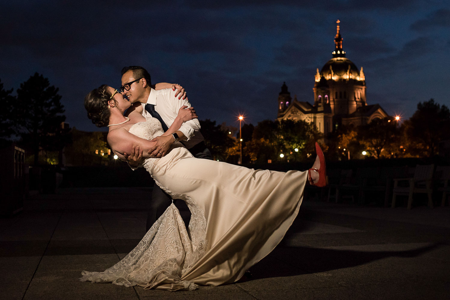 groom dipping the bride in front of the St Paul Cathedral