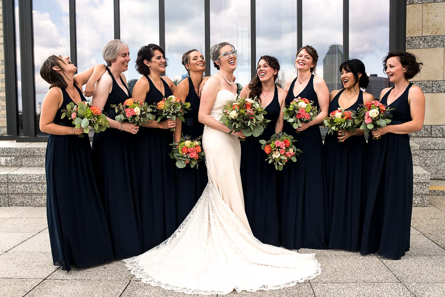 bride with her bridesmaids wearing navy on the patio of the Minnesota History Center