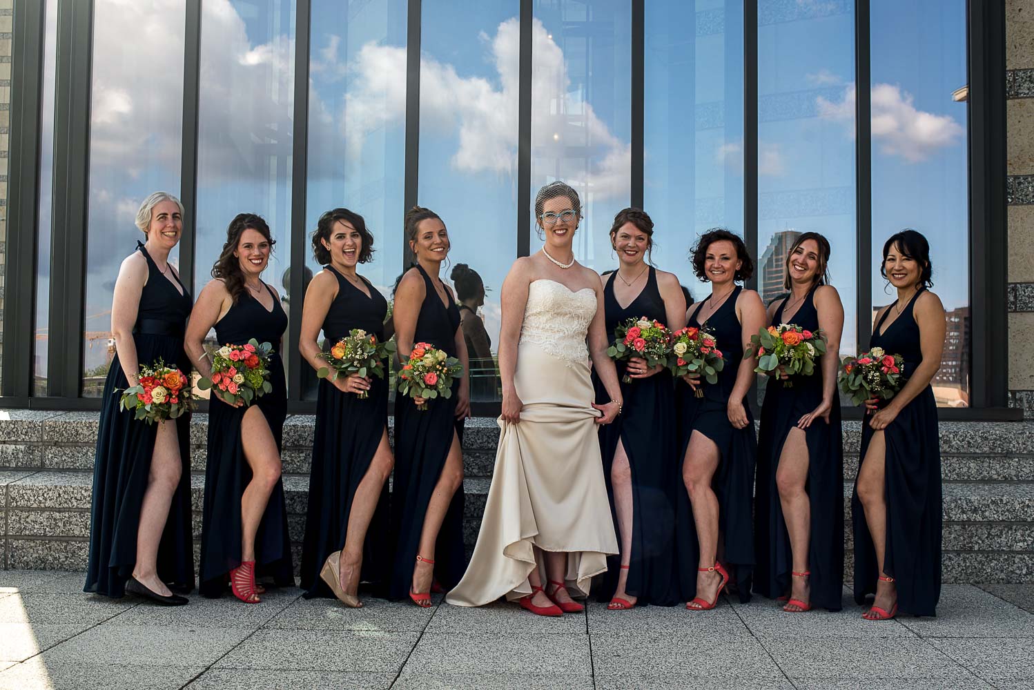 bride and bridesmaids showing off their legs with their salmon shoes and navy bridesmaid dressed