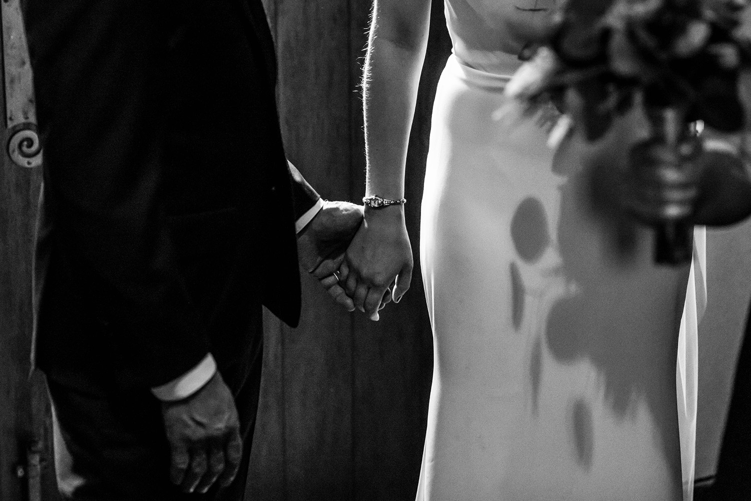 bride and father holding hands before walking down the aisle